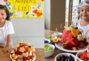 Filha de Leo Santana e Lore Improta ganha bolo de aniversário de frutas na escola
